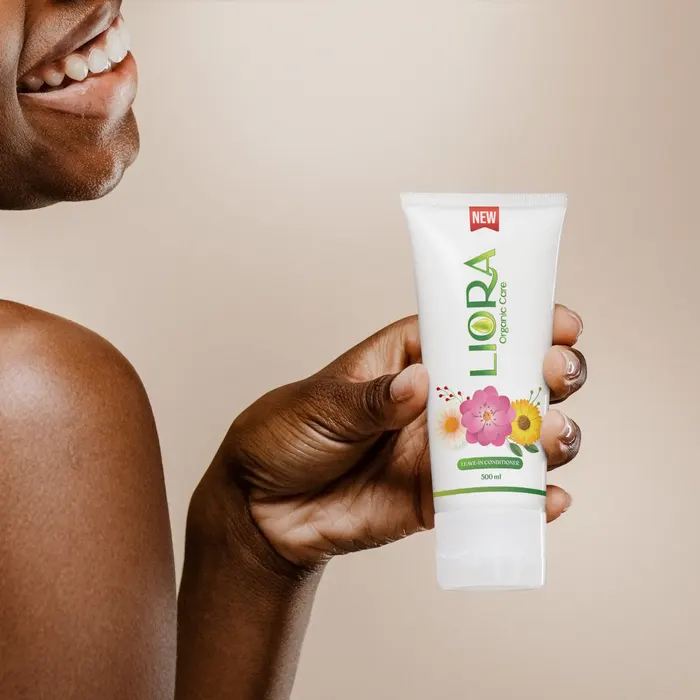 A smiling woman holding Liora leave-in conditioner